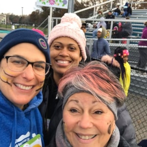 Girls on the Run coaches smiling outdoors